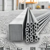 A detailed illustration showing smooth and ribbed steel reinforcement bars (rebar) placed side by side for comparison, with clear visual distinction between the smooth surface of one bar and the helical or longitudinal ribs on the other, set against a neutral construction site background with concrete forms and gravel, emphasizing texture and material properties, no text, no labels, no digits, no people, no machinery